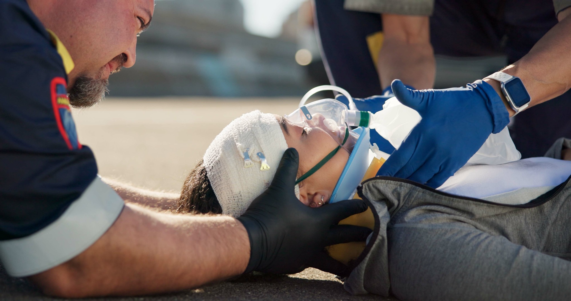 Paramedic, emergency and injury on road with concussion check from accident with help, EMT man and
